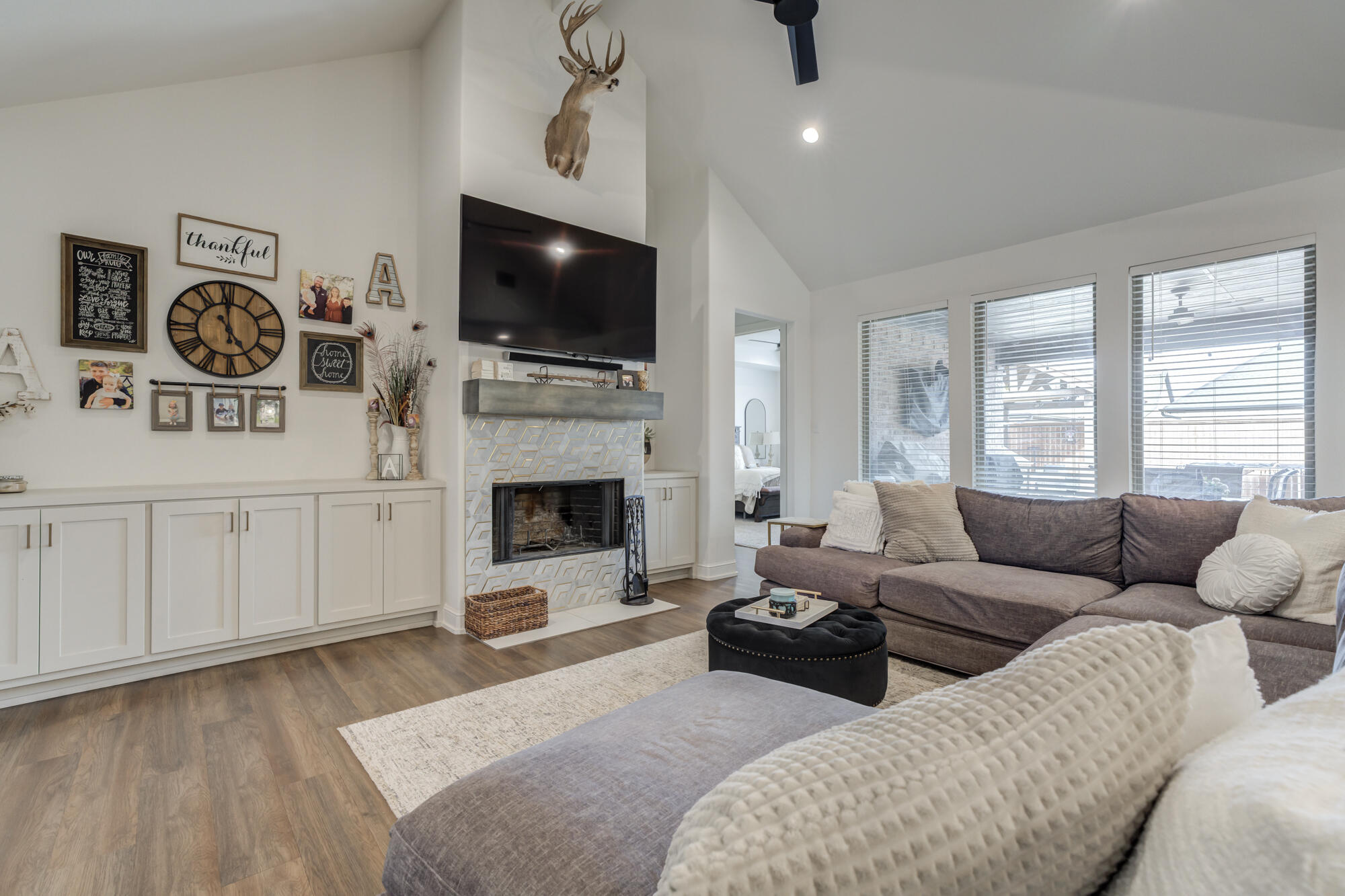 4624 139th Street Lubbock, TX 79424 - Photo 2 of 52 a living room with furniture a flat screen tv and a fireplace