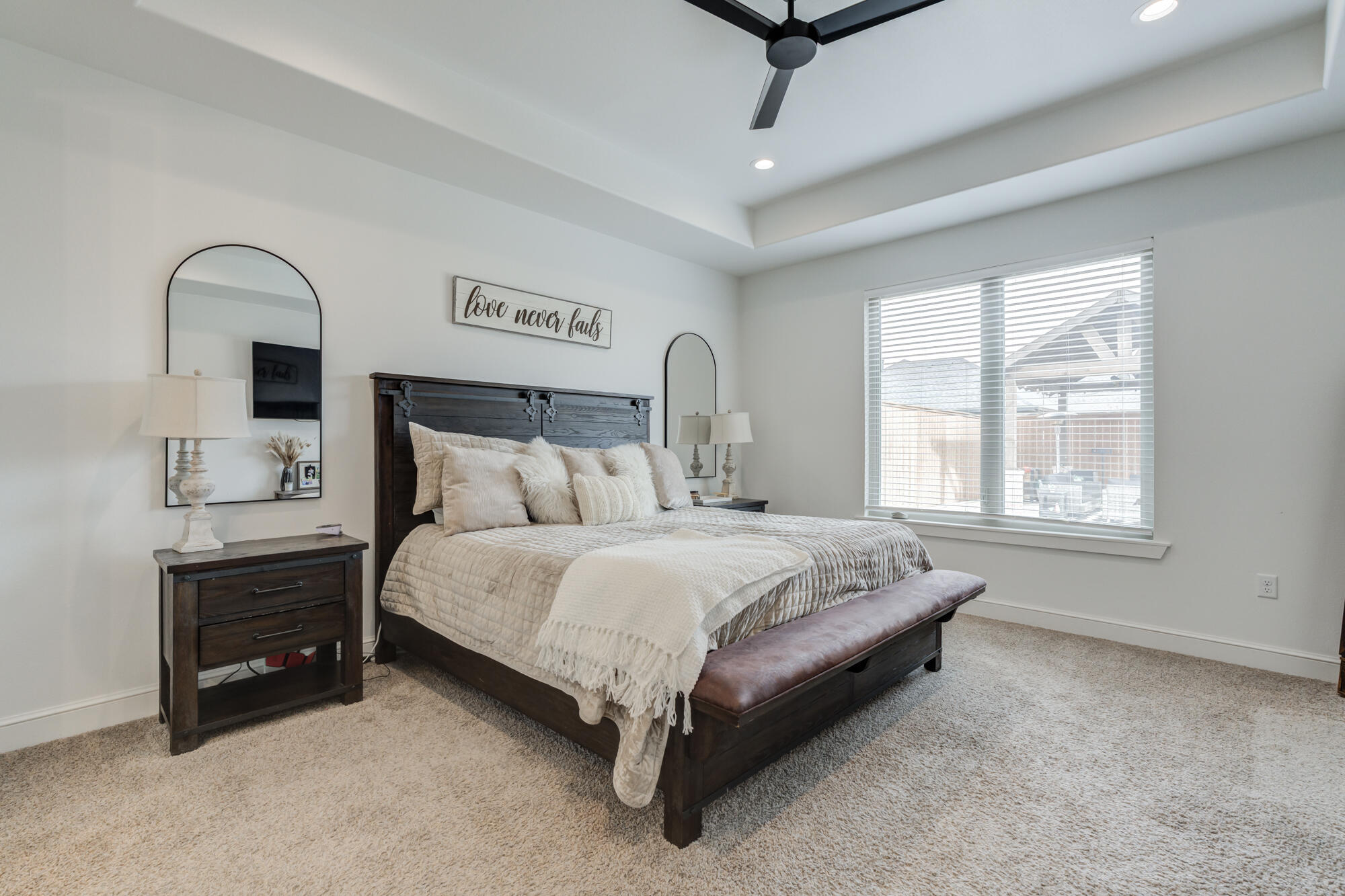 4624 139th Street Lubbock, TX 79424 - Photo 27 of 52 a spacious bedroom with a bed a dresser and windows
