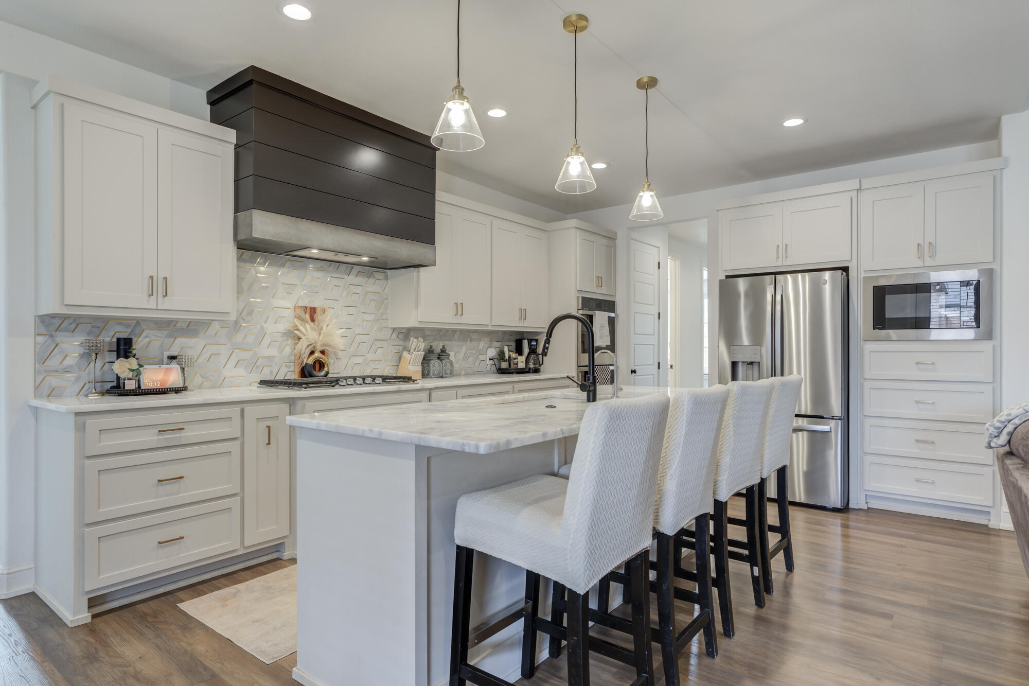 4624 139th Street Lubbock, TX 79424 - Photo 3 of 52 a kitchen with stainless steel appliances granite countertop a stove a sink a refrigerator a microwave oven a refrigerator with white cabinets and wooden floor