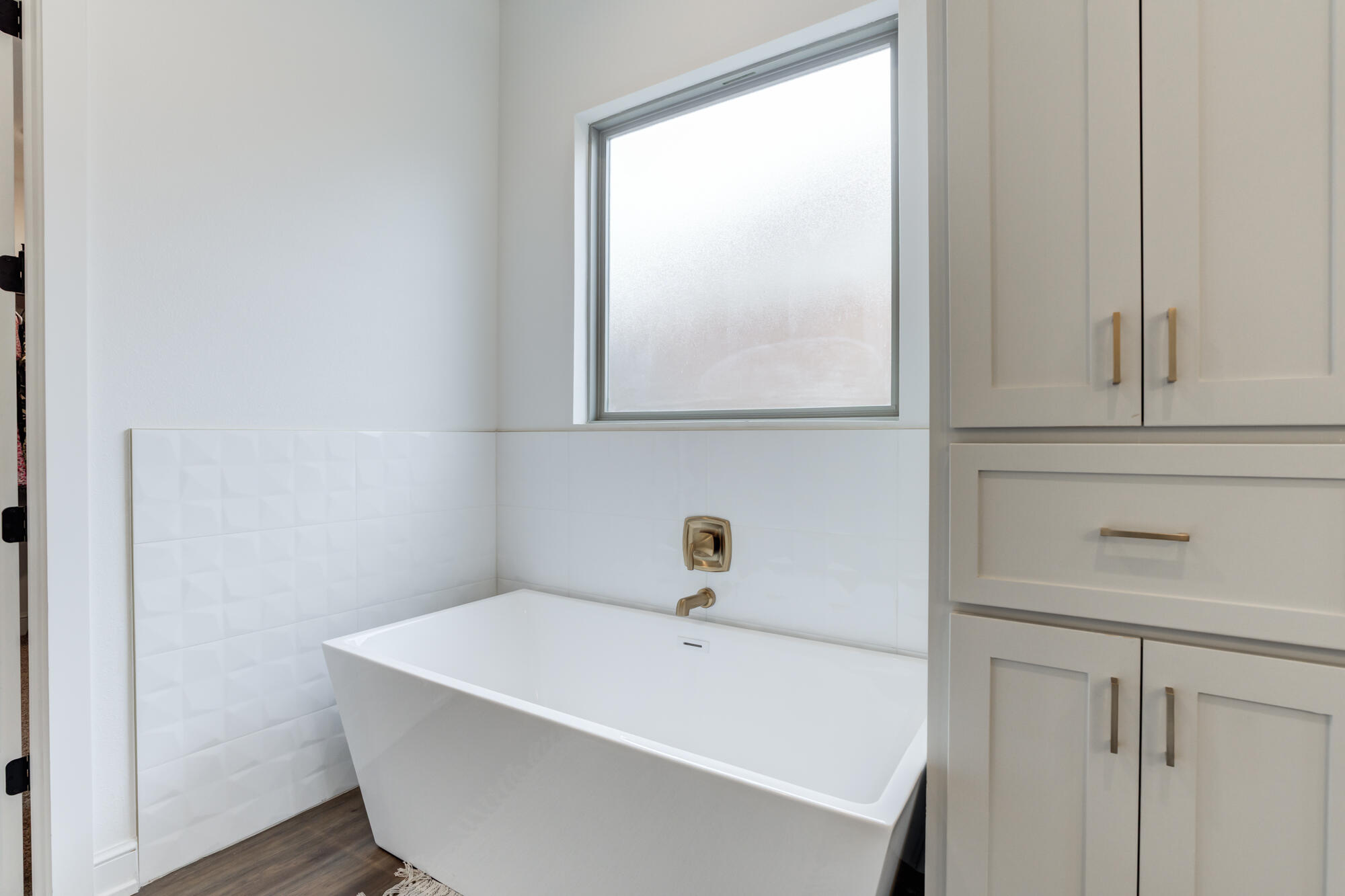 4624 139th Street Lubbock, TX 79424 - Photo 32 of 52 a white bath tub sitting next to a window