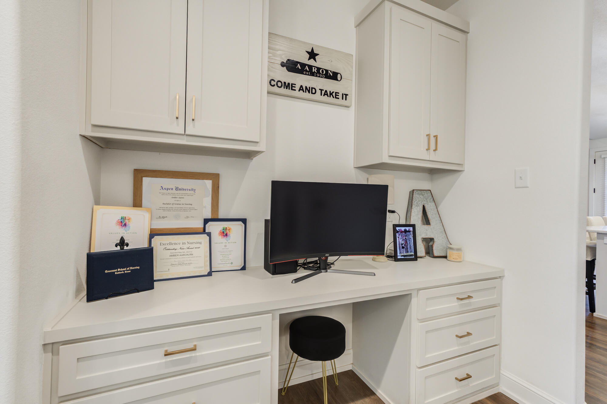 4624 139th Street Lubbock, TX 79424 - Photo 41 of 52 a kitchen with a microwave a stove and white cabinets