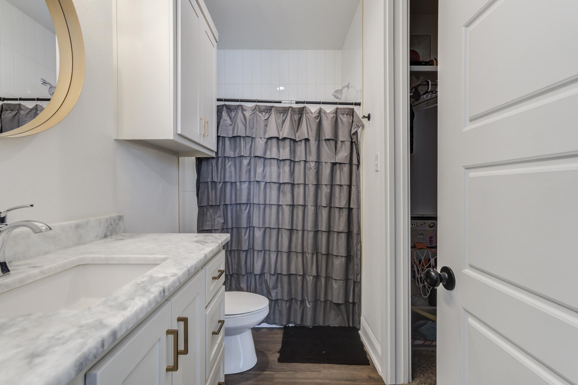 4624 139th Street Lubbock, TX 79424 - Photo 45 of 52 a bathroom with a granite countertop sink toilet and shower
