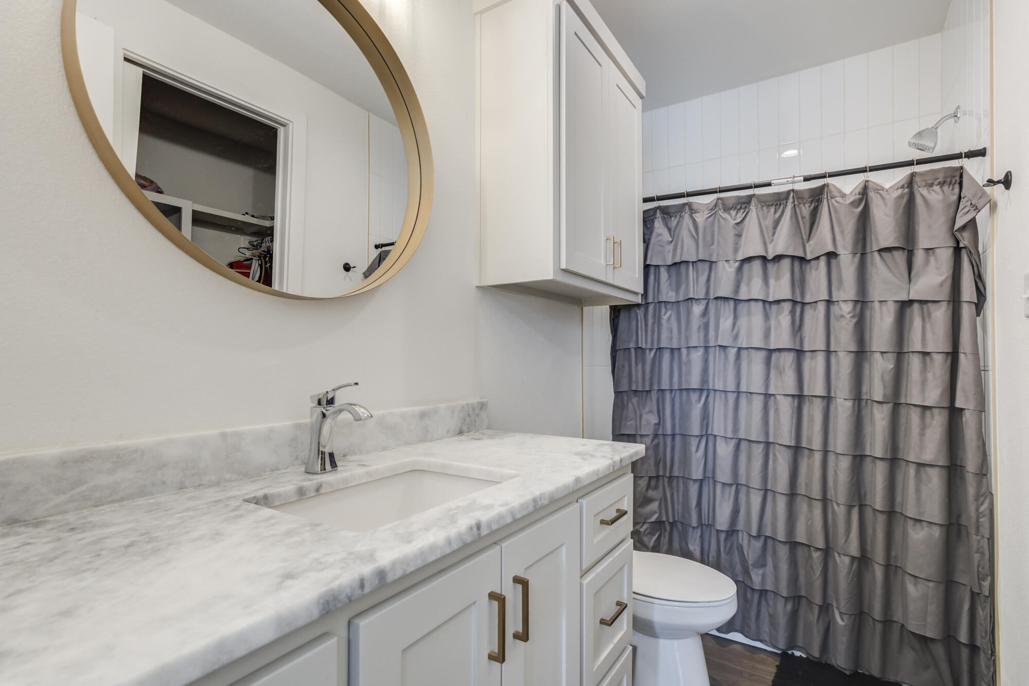 4624 139th Street Lubbock, TX 79424 - Photo 46 of 52 a bathroom with a granite countertop sink a toilet and a mirror