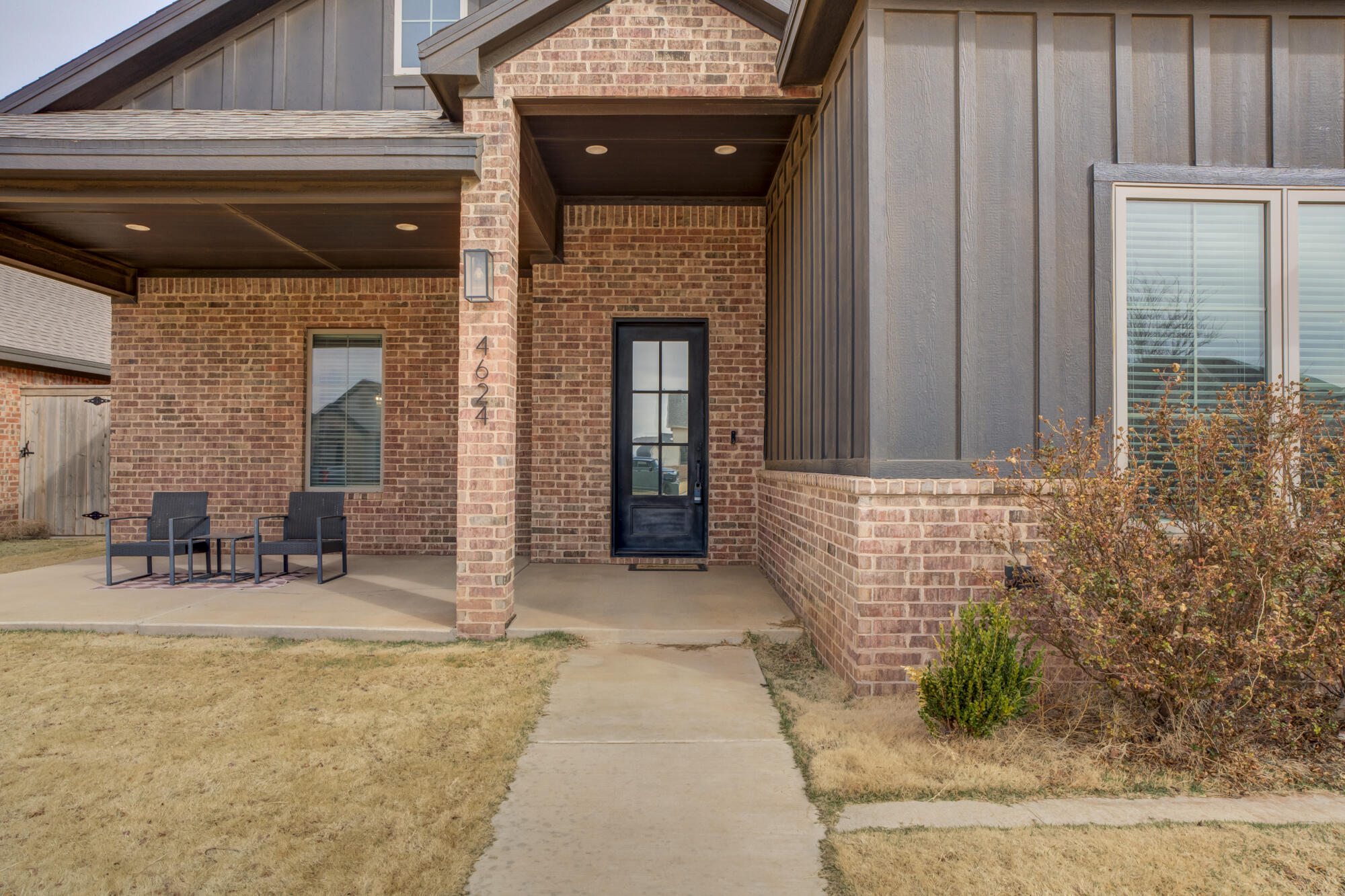4624 139th Street Lubbock, TX 79424 - Photo 8 of 52 a front view of a house with large windows and a table and chairs