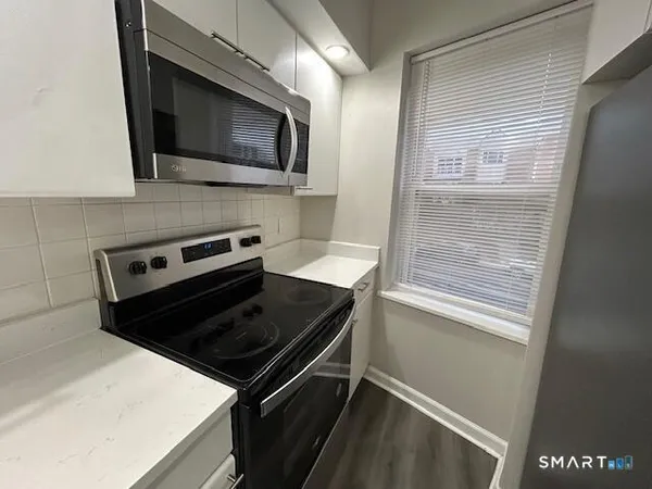a kitchen with a microwave and a sink