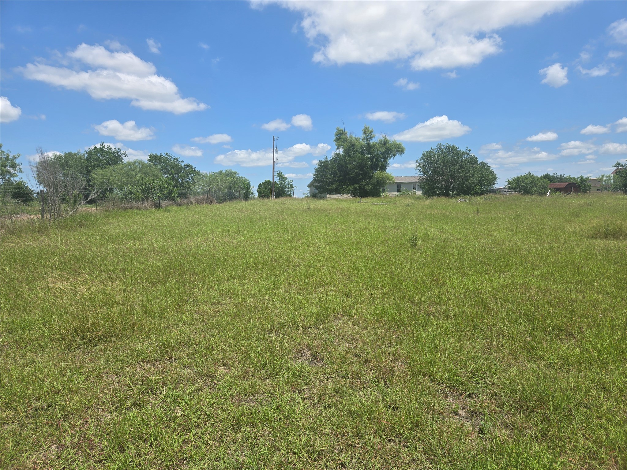 150 Longhorn Loop Kyle, TX 78640 - Photo 12 of 13 a view of a field with an trees in the background