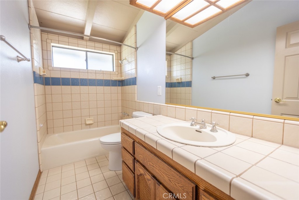 14732 Candeda Place Tustin, CA 92780 - Photo 20 of 37 a bathroom with a sink a toilet a mirror and bathtub