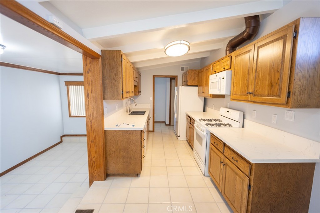14732 Candeda Place Tustin, CA 92780 - Photo 30 of 37 a kitchen with a sink a stove top oven and wooden floor