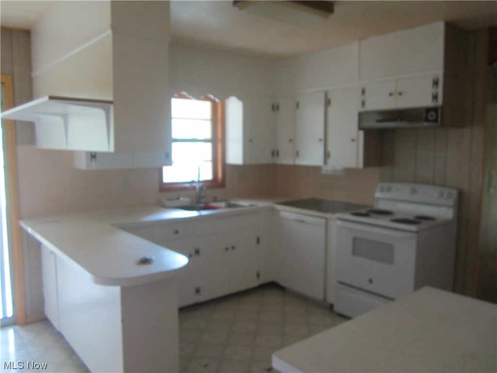 200 Summit Road Marietta, OH 45750 - Photo 29 of 35 Kitchen featuring white electric range, white cabinets, light countertops, and light tile floors