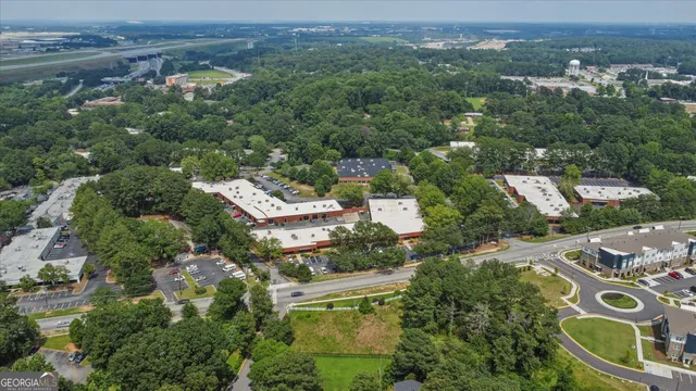an aerial view of multiple houses with a yard