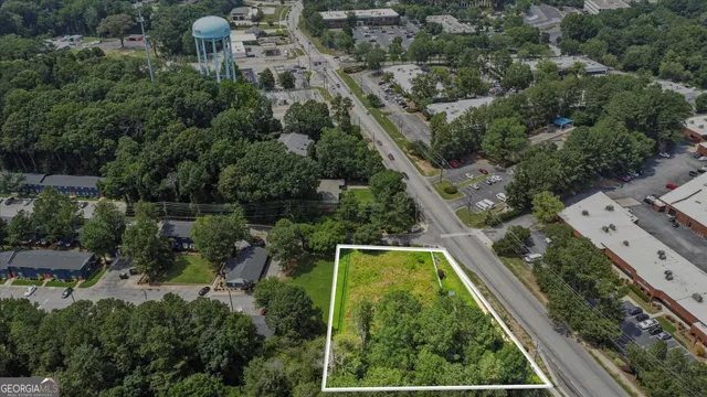 an aerial view of residential houses with outdoor space and street view