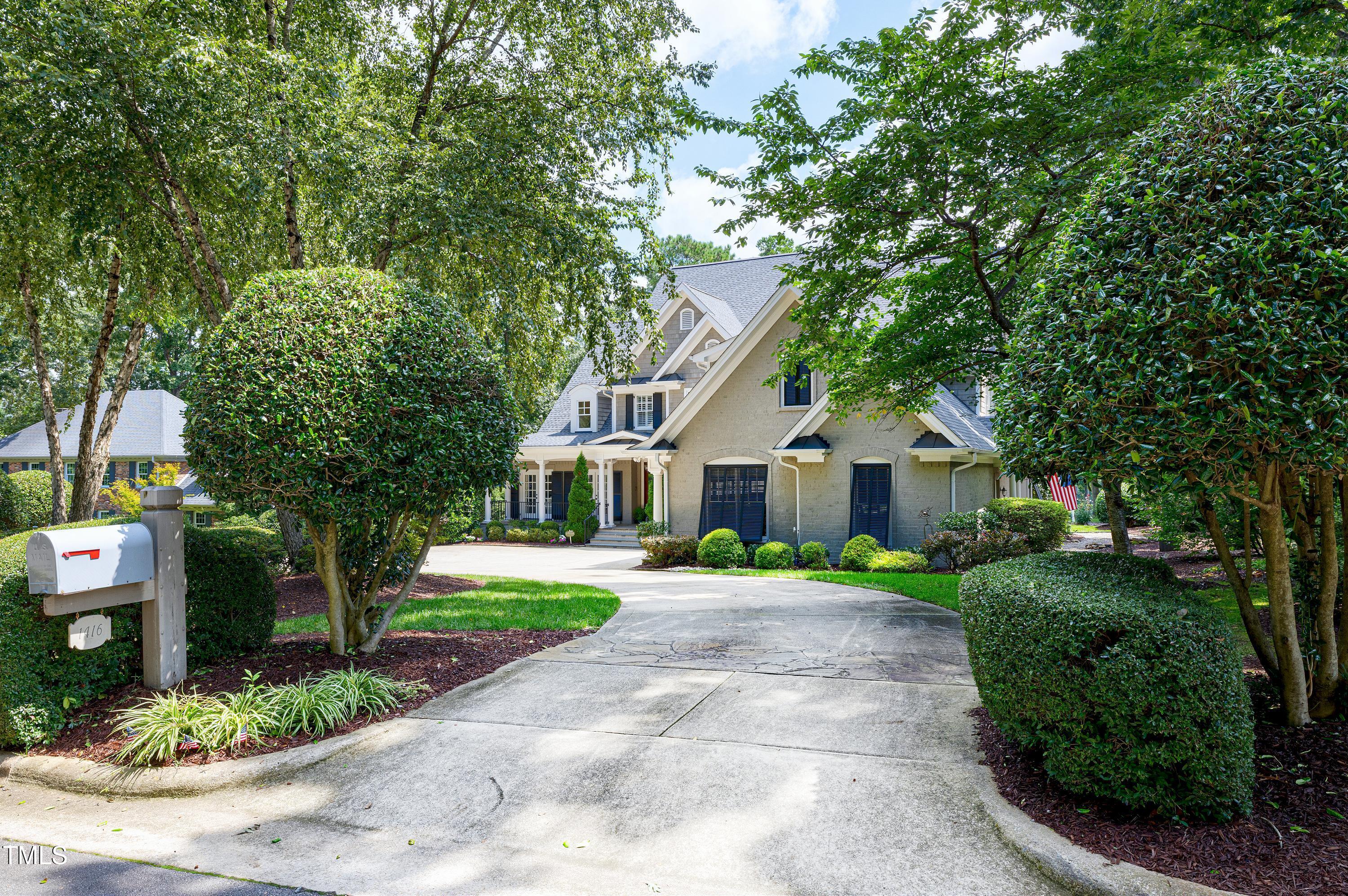 1416 Hedgelawn Way Raleigh, NC 27615 - Photo 3 of 56 a front view of a house with a yard and trees