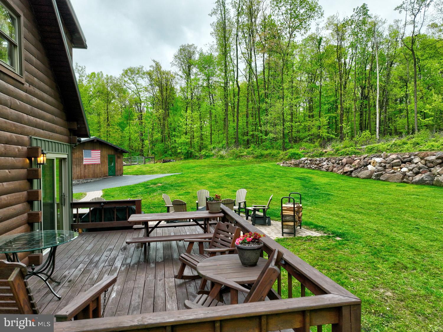 491 Sheep Hill Road Newmanstown, PA 17073 - Photo 27 of 30 a view of a wooden deck with chairs and a yard