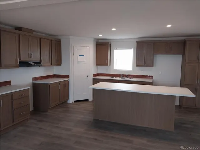 a large kitchen with stainless steel appliances granite countertop a stove and a sink