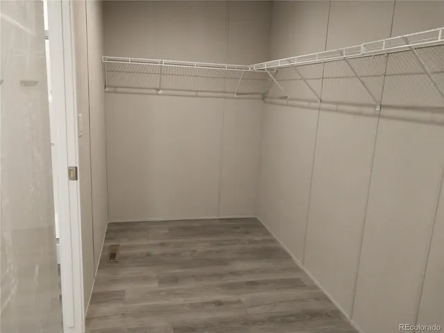 a view of a room with wooden floor and cabinet