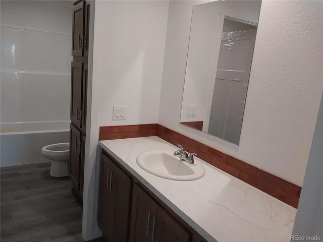 a bathroom with a toilet and a bathtub