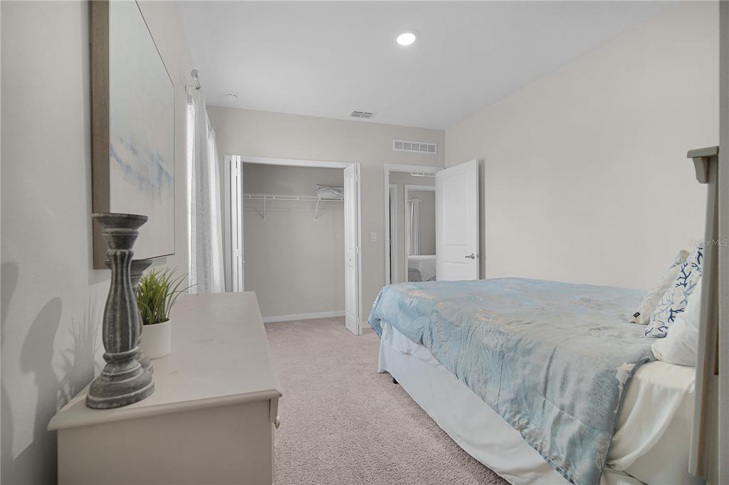 418 Fleming Street Sebastian, FL 32958 - Photo 22 of 38 a bedroom with a bed and a potted plant