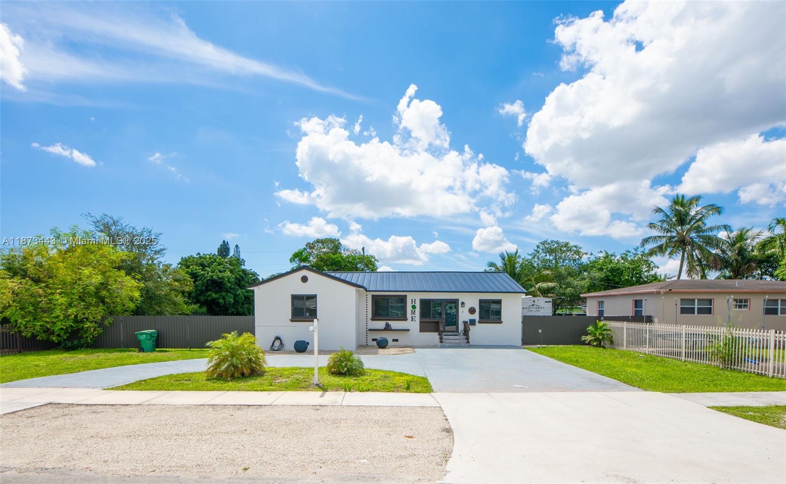 a front view of a house with a garden and trees