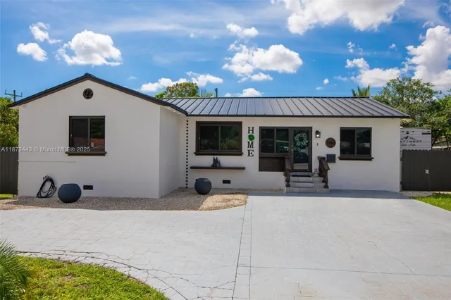 a view of a house with a swimming pool and sitting area
