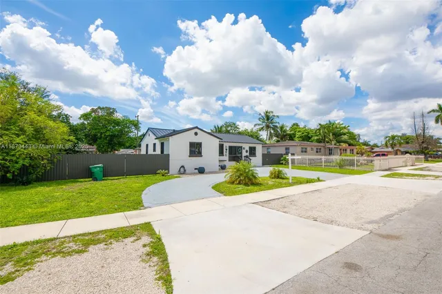 a view of a house with swimming pool and a yard