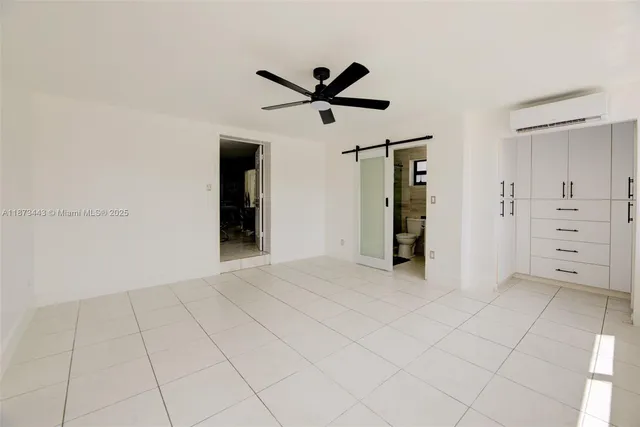 a view of an empty room with closet