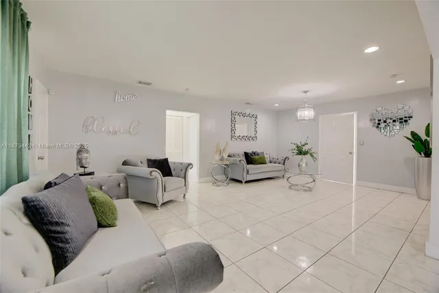 a living room with furniture and a potted plant