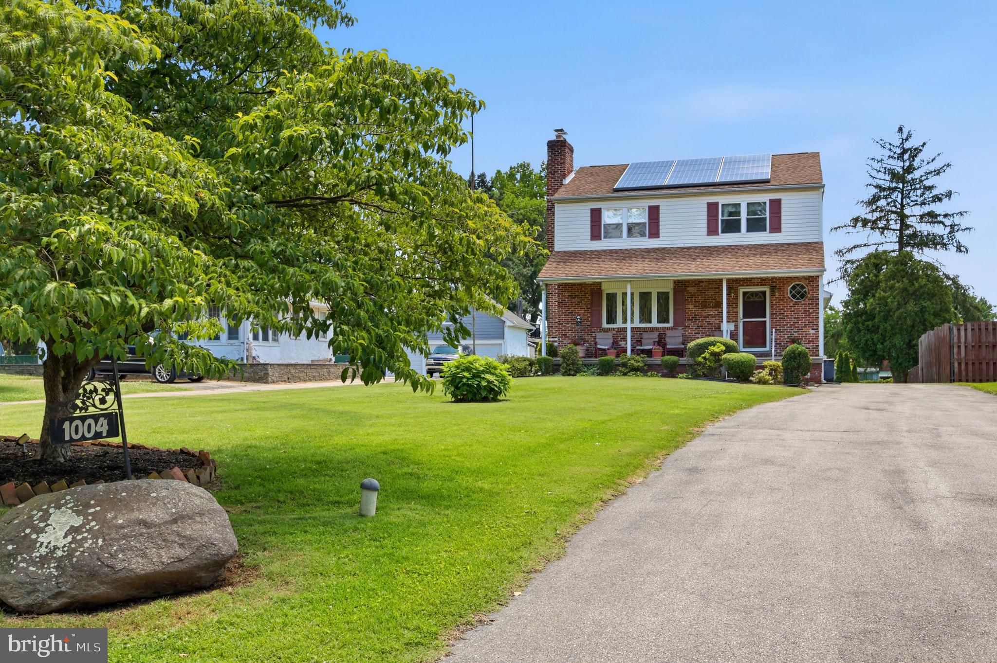 1004 Green Lane Secane, PA 19018 - Photo 3 of 49 a front view of a house with garden and trees