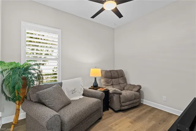 a living room with furniture and a potted plant
