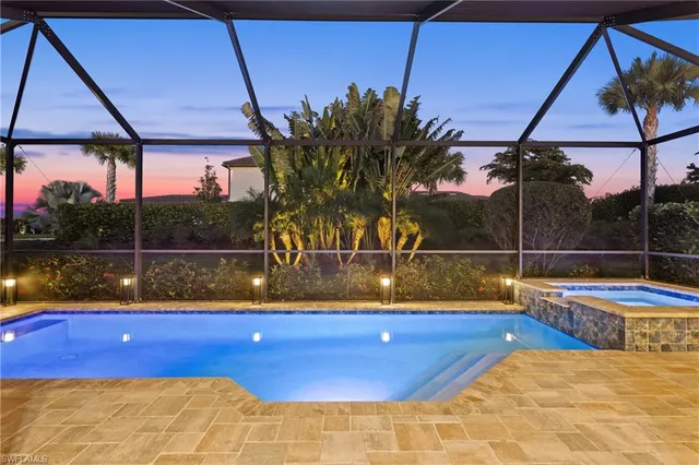 a view of a pool with a backyard of a house