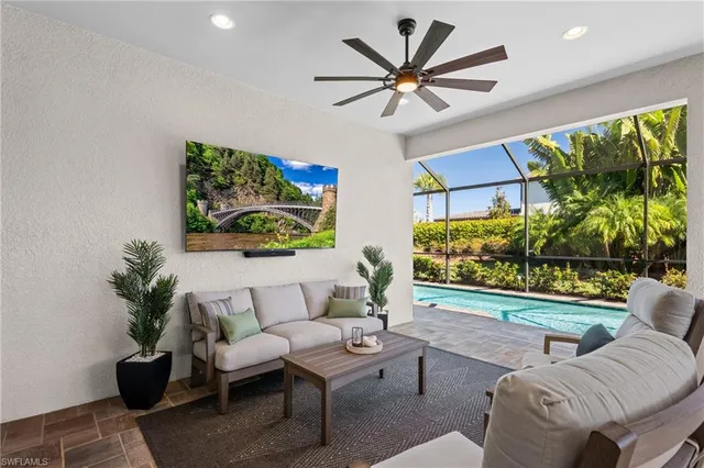 a living room with furniture and a large window