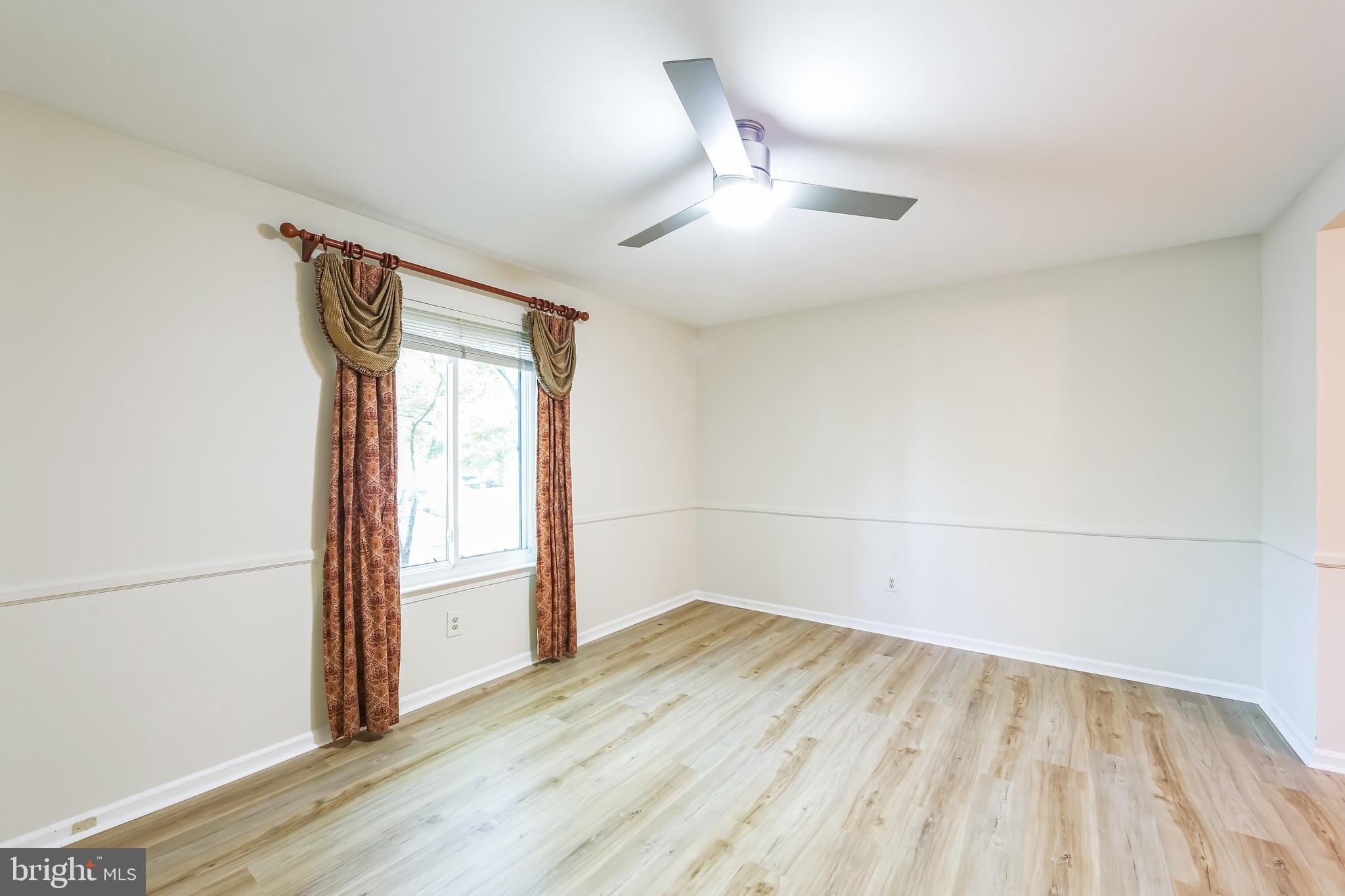 1804 Mountainview Drive, Unit 1804 Chesterbrook, PA 19087 - Photo 12 of 20 an empty room with wooden floor fan and windows