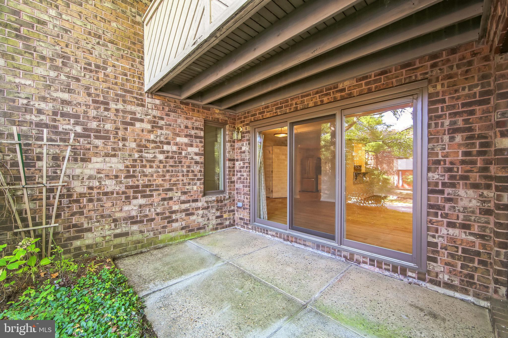 1804 Mountainview Drive, Unit 1804 Chesterbrook, PA 19087 - Photo 19 of 20 a view of a porch with a table and chairs and floor to ceiling window