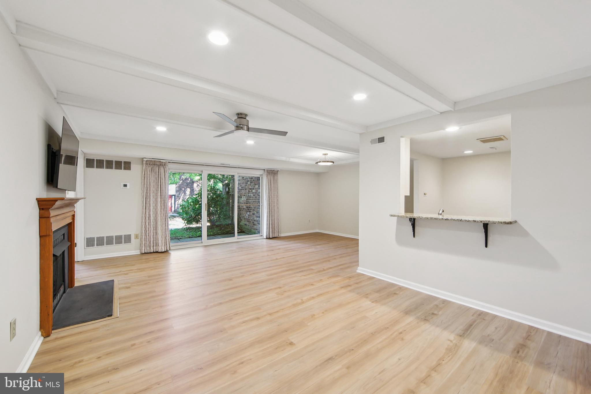 1804 Mountainview Drive, Unit 1804 Chesterbrook, PA 19087 - Photo 4 of 20 an empty room with wooden floor and a fireplace