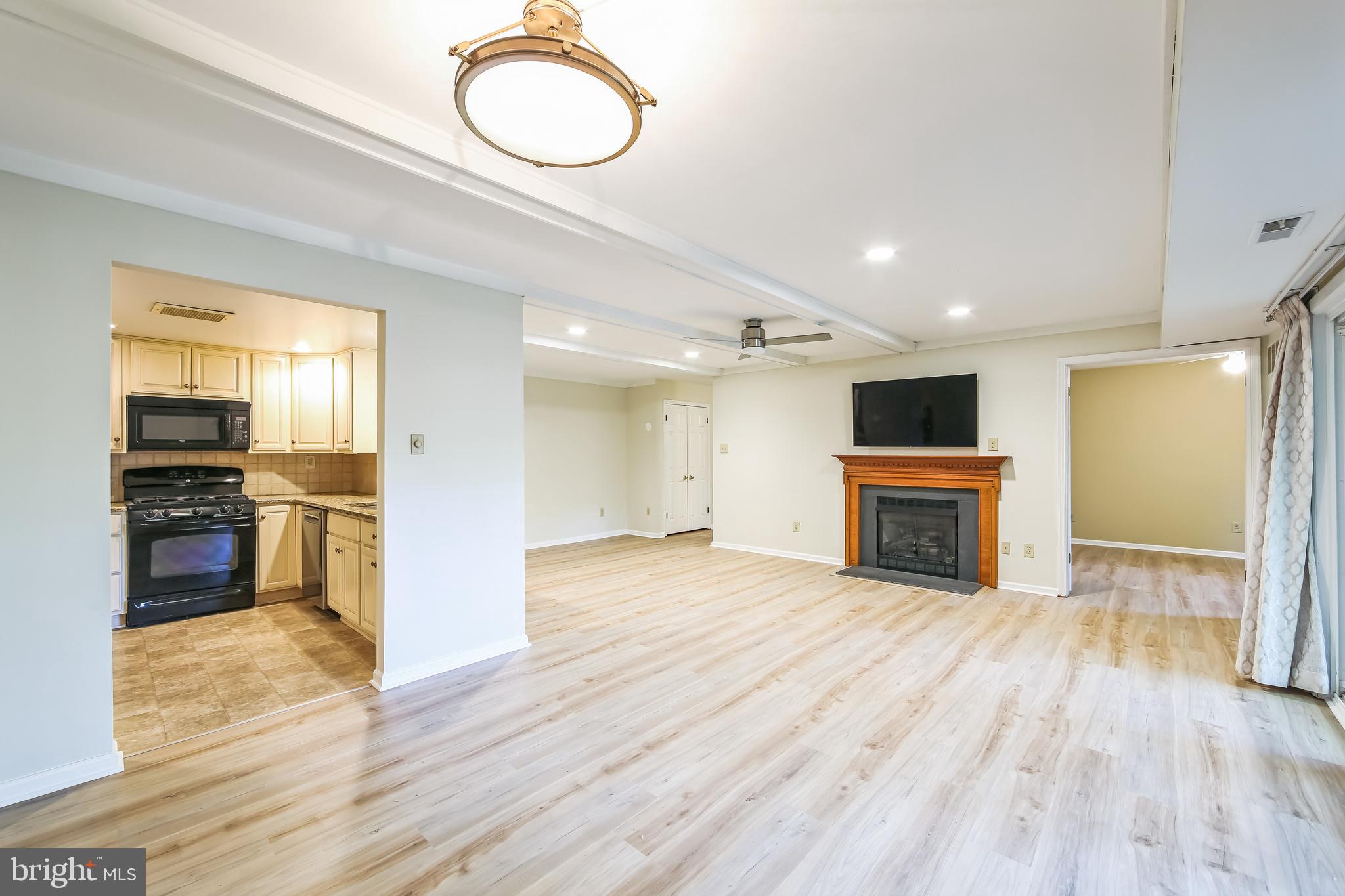 1804 Mountainview Drive, Unit 1804 Chesterbrook, PA 19087 - Photo 7 of 20 a view of empty room with wooden floor and kitchen