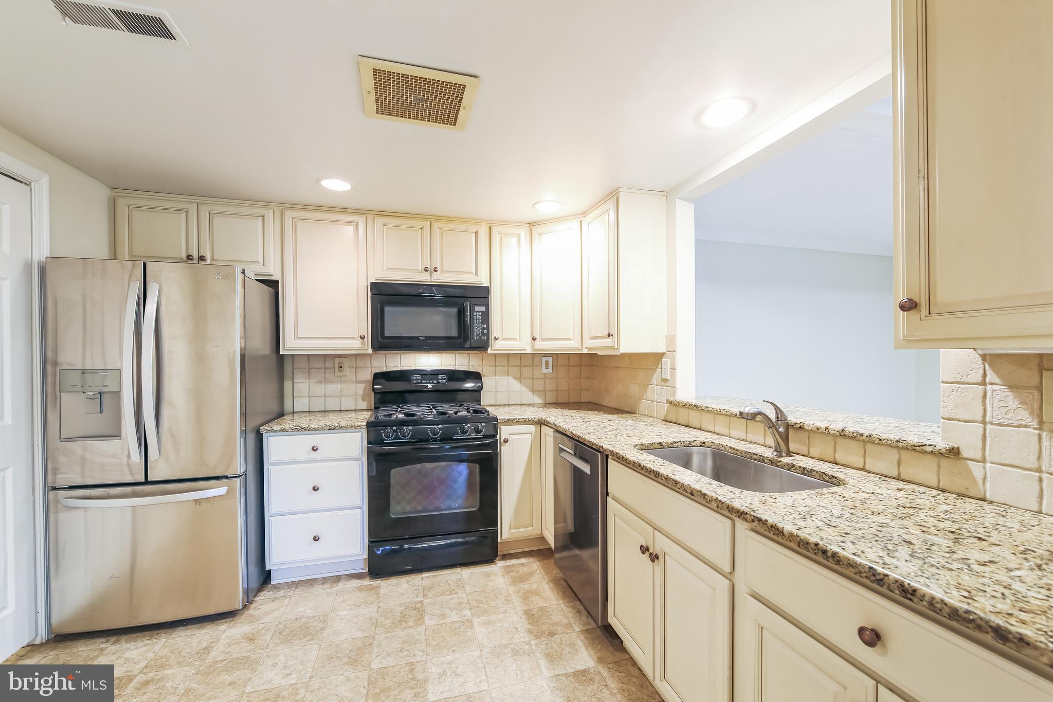 1804 Mountainview Drive, Unit 1804 Chesterbrook, PA 19087 - Photo 9 of 20 a kitchen with stainless steel appliances granite countertop a refrigerator sink and stove