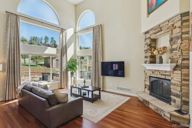 a living room with furniture a fireplace and a flat screen tv
