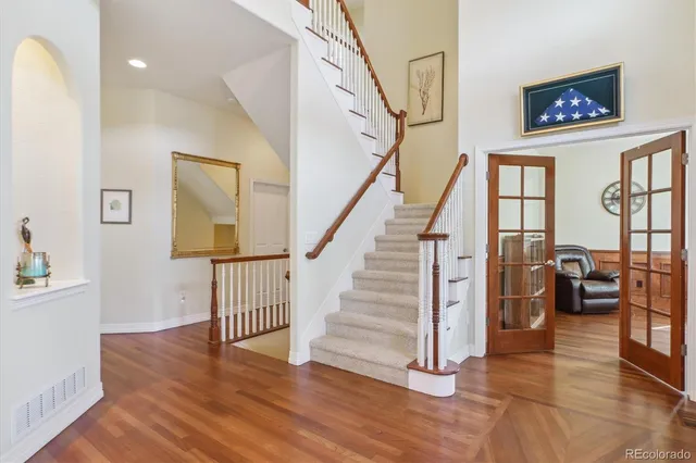 a view of entryway and hall with wooden floor