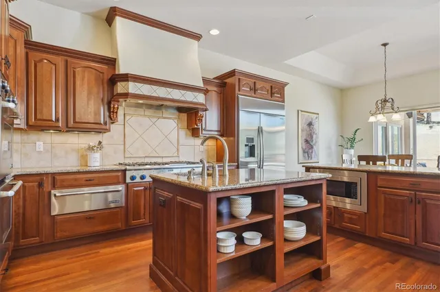 a kitchen with stainless steel appliances granite countertop a sink and cabinets
