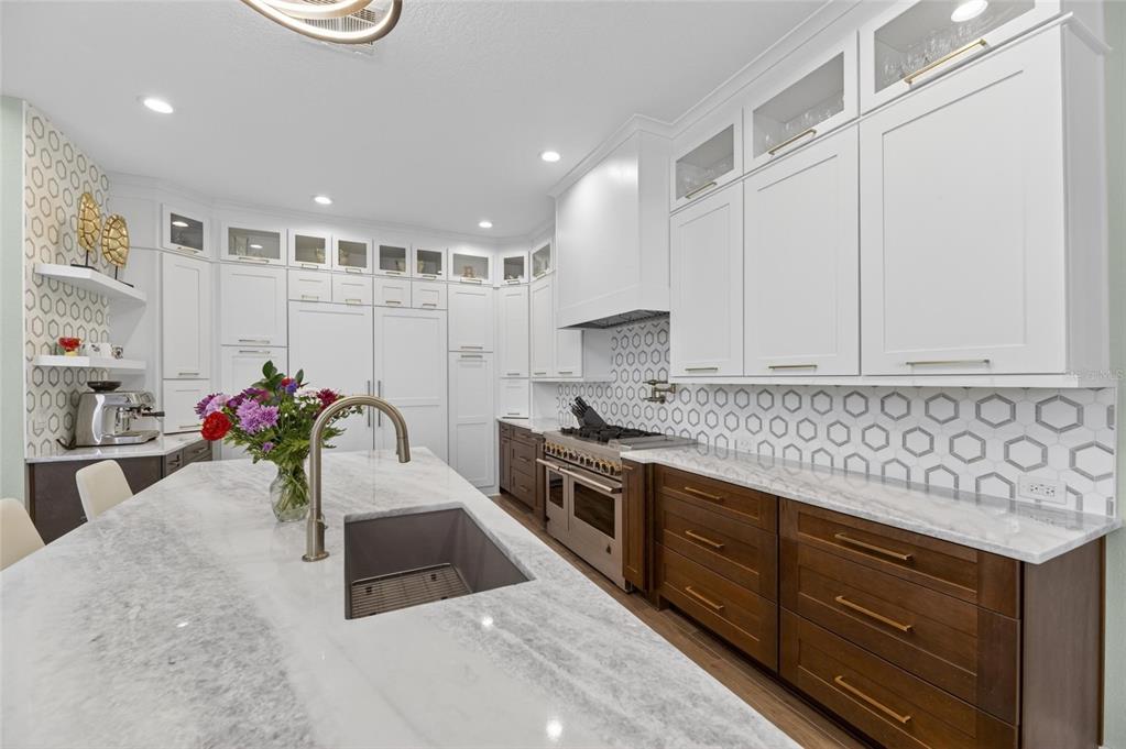 508 Islebay Drive Apollo Beach, FL 33572 - Photo 28 of 98 a kitchen with stainless steel appliances granite countertop a sink stove and cabinets