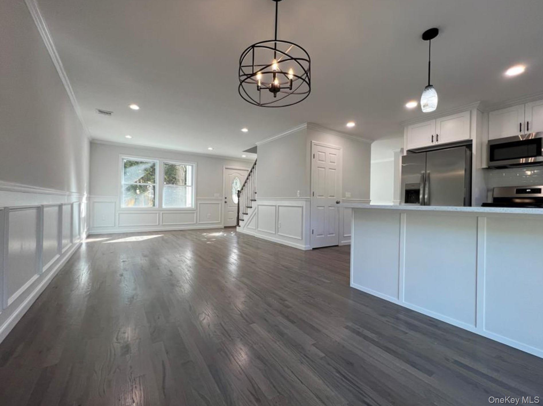 492 Blue Point Road Farmingville, NY 11738 - Photo 4 of 9 a view of a kitchen with wooden floor and a window