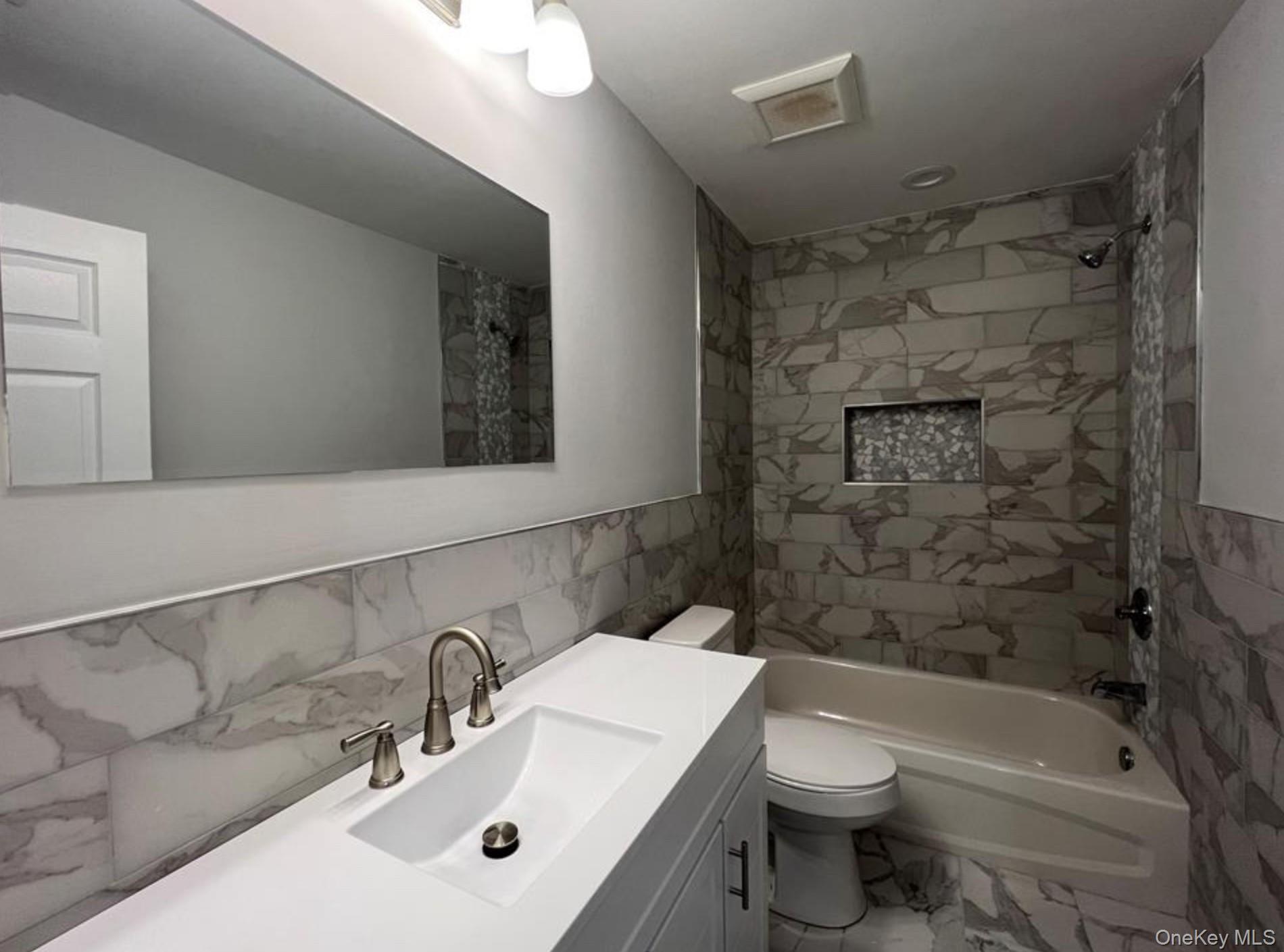 492 Blue Point Road Farmingville, NY 11738 - Photo 5 of 9 a bathroom with a sink a toilet and shower