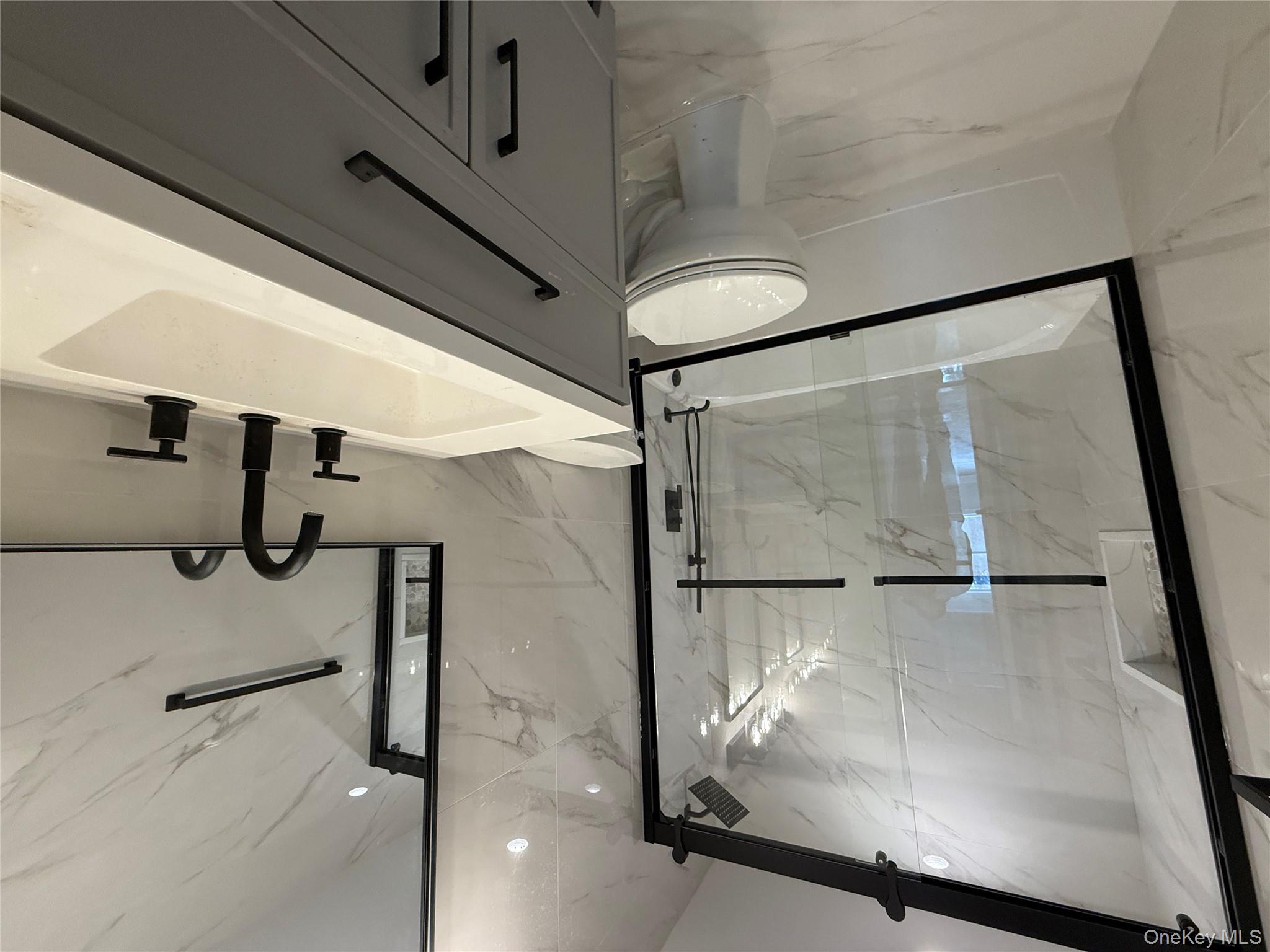 492 Blue Point Road Farmingville, NY 11738 - Photo 9 of 9 a bathroom with a sink a toilet and a shower