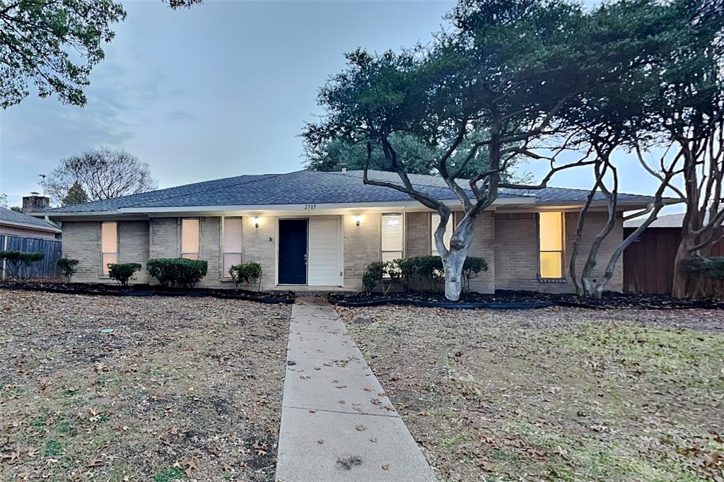 2705 South Colfax Circle Plano, TX 75075 - Photo 1 of 19 a front view of a house with garden