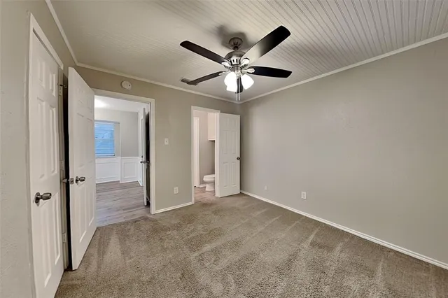 a view of an empty room with a ceiling fan