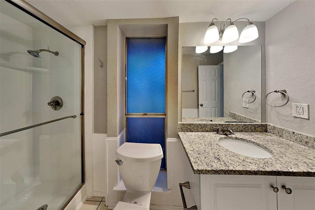 2705 South Colfax Circle Plano, TX 75075 - Photo 17 of 19 a bathroom with a granite countertop sink toilet and shower