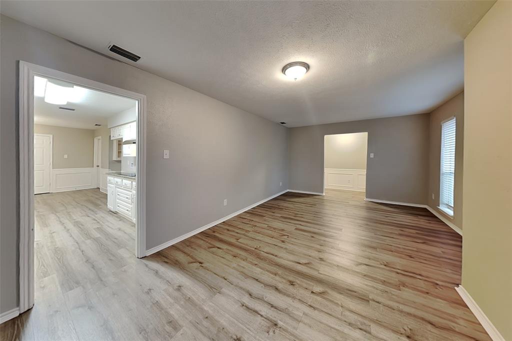 2705 South Colfax Circle Plano, TX 75075 - Photo 7 of 19 wooden floor in an empty room with a mirror