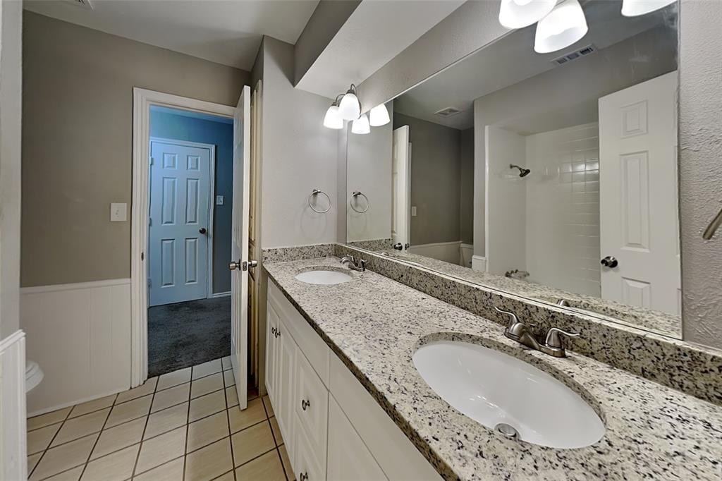 2705 South Colfax Circle Plano, TX 75075 - Photo 10 of 19 a bathroom with a granite countertop double vanity sink a mirror and a shower