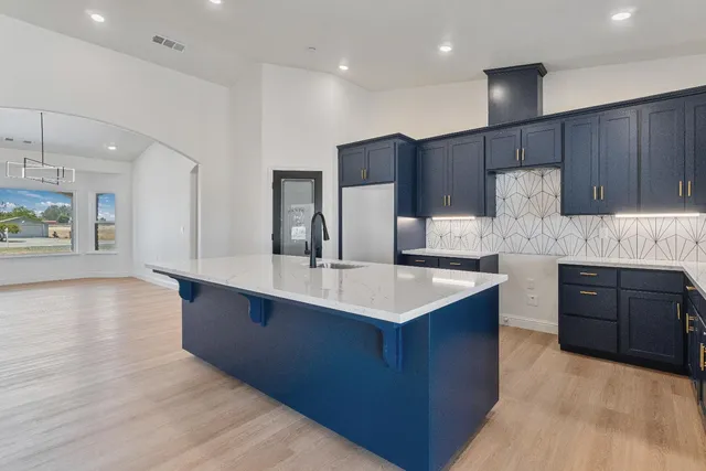 a kitchen with stainless steel appliances wooden cabinets a sink and a stove