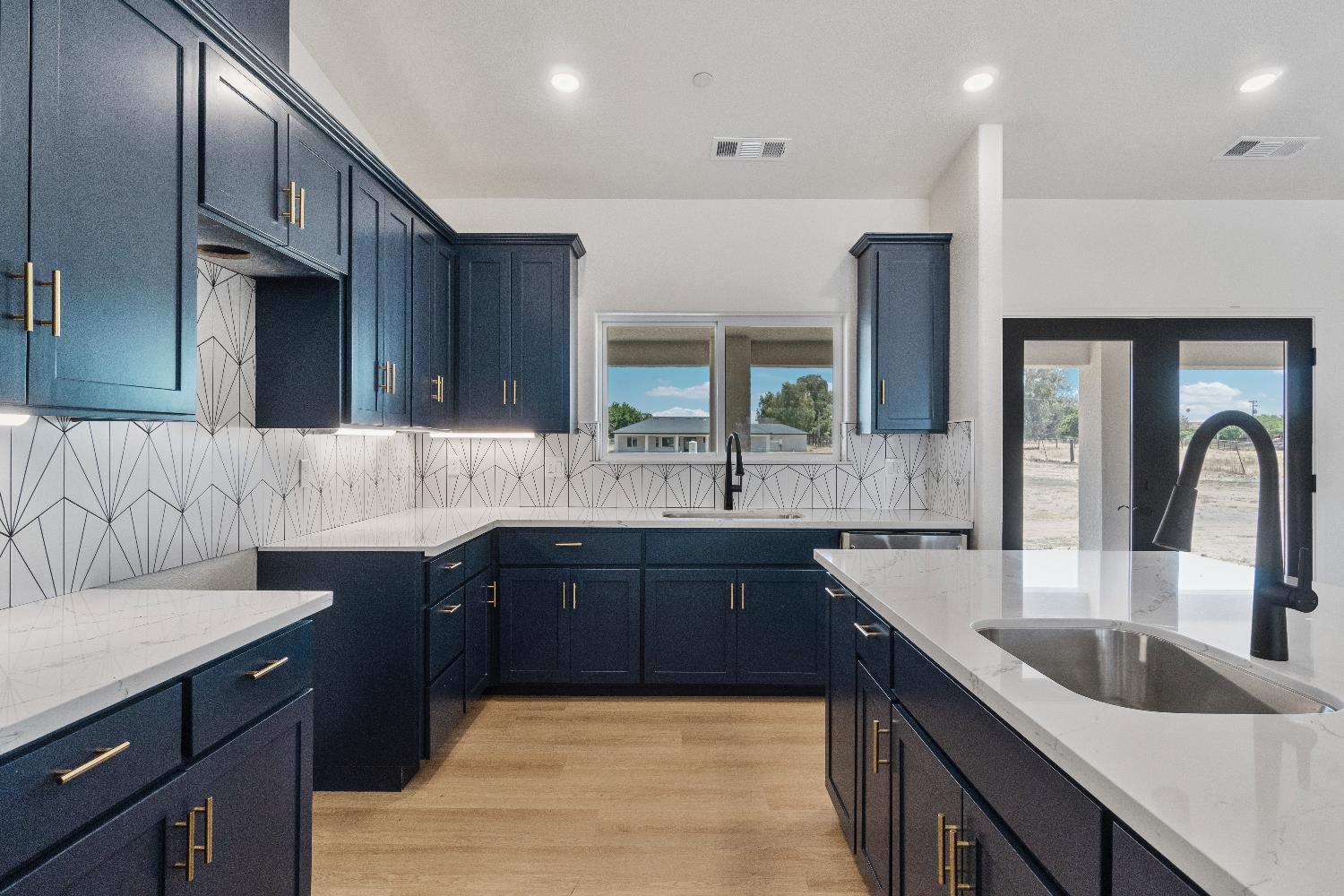 21035 Forest Glen Road Madera, CA 93638 - Photo 15 of 31 a large kitchen with stainless steel appliances wooden cabinets a sink and a dishwasher