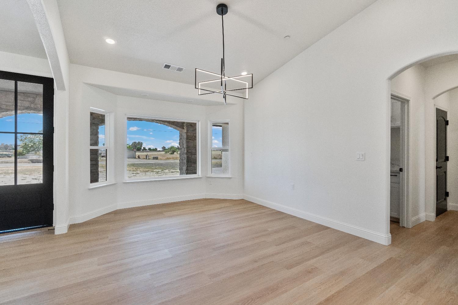 21035 Forest Glen Road Madera, CA 93638 - Photo 16 of 31 a view of an empty room with a window and wooden floor